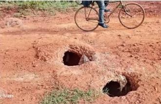 Deep potholes on the Munana-Sigalame-Sio Port road before the upgrade